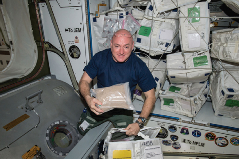 Former U.S. astronaut Scott Kelly on board the International Space Station with tomato seeds from the Tomatosphere project