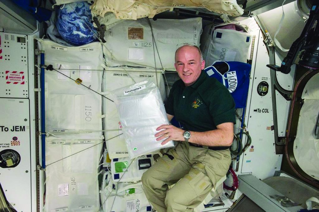 Astronaut Jeff Williams on board the International Space Station with the 1.2 million TomatosphereTM tomato seeds.